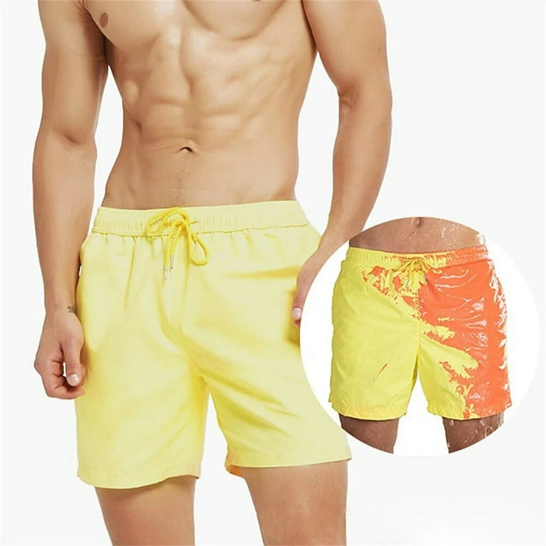 A Person is Wearing Men Color Changing  Beach Shorts in Yellow Color.