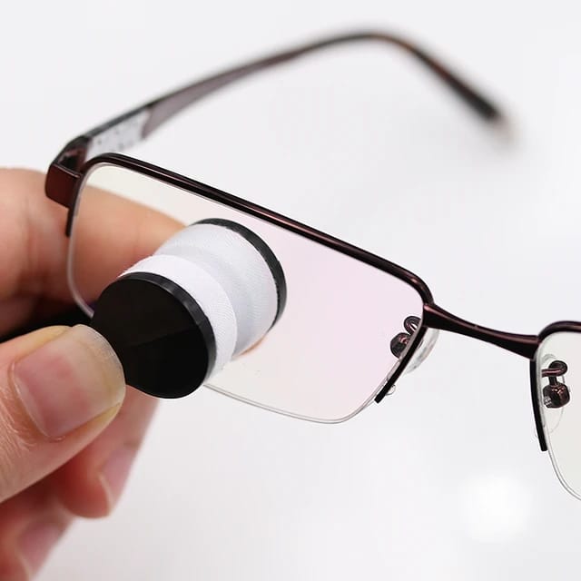 Someone cleaning glass with a Microfiber Eyeglass Cleaning Tool