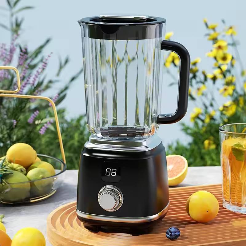 Black Portable Citrus Juicer Blender on a table with fruits and a glass of juice in a garden setting