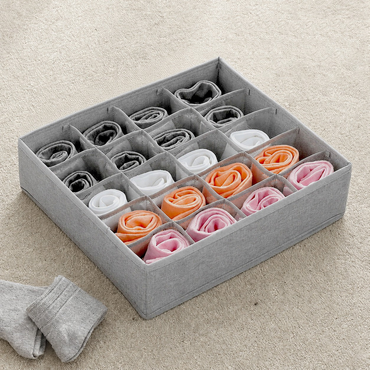 20 Grid Foldable Drawer Organizer Storage Box with neatly folded socks in various colors on a beige carpet.