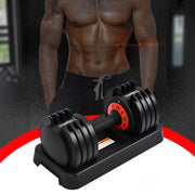 An adjustable dumbbell set is placed on its base. The setting appears to be a gym or workout area.