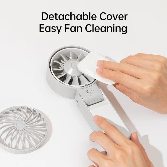 A person cleaning a Jisulife Handheld Portable Fan