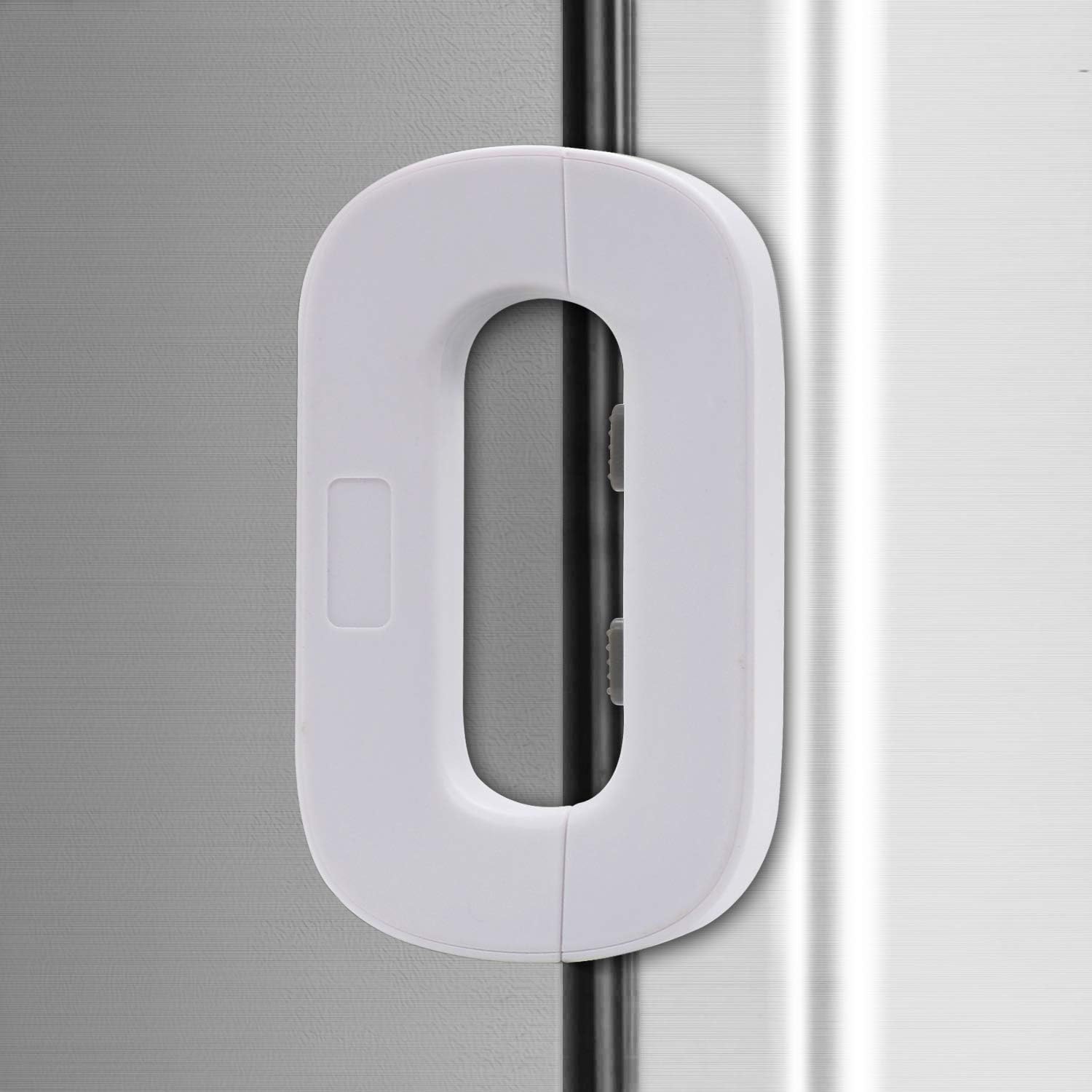 A close-up of a refrigerator child safety lock installed on a refrigerator door.