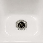 Close-up of a white kitchen sink with a Sink Drain Strainer 