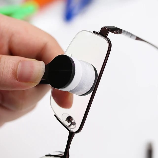 Someone cleaning glass with a Microfiber Eyeglass Cleaning Tool