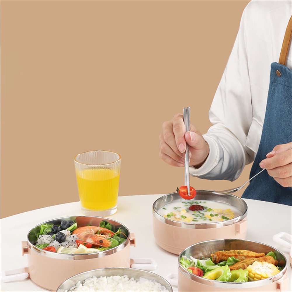 A Person is Eating from Stainless Steel Lunch Box.