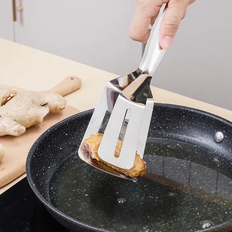 Someone cooking with the help of Stainless Steel Food Tongs