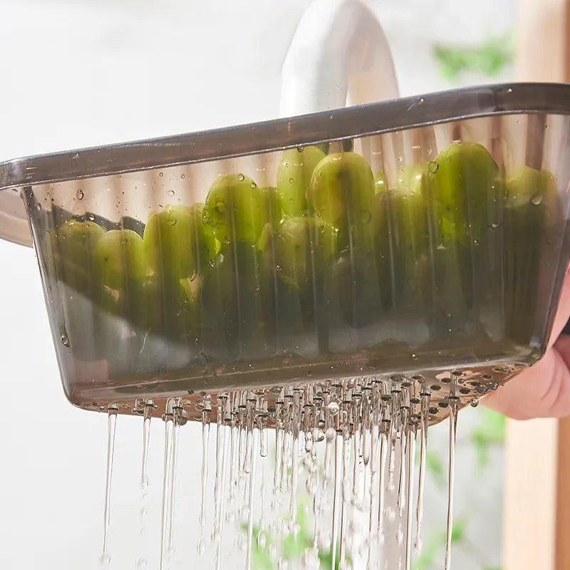 A person washing grapes in a Telescopic Sink Drain Basket