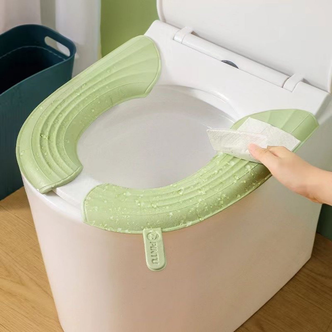 A Person is Wiping Toilet Seat Cushion Cover with a Tissue.