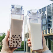 Two Persons are Holding Transparent Plastic Juice Bottle With Juice.
