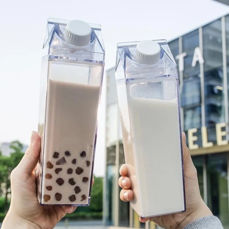 Two Persons are Holding Transparent Plastic Juice Bottle With Juice.