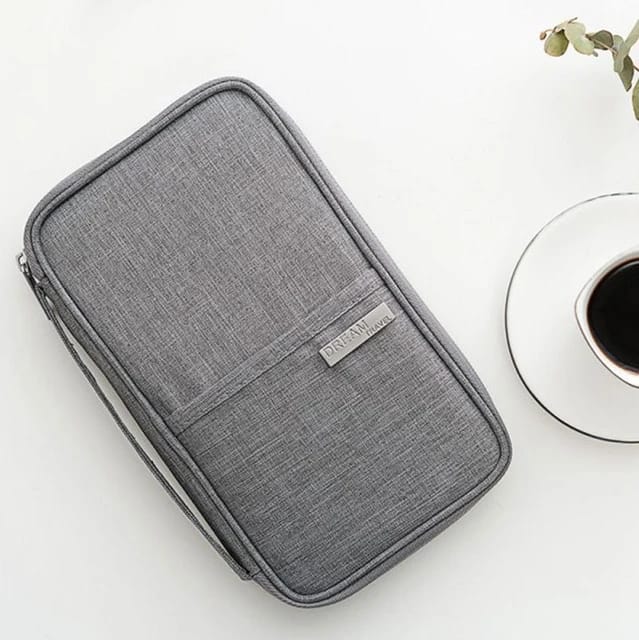 Travel Passport and Document Organizer Bag placed on the table next to a vase