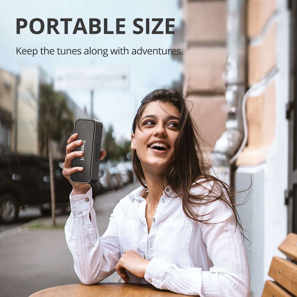 A Woman is Enjoying With Tronsmart T2 Mini 2023 Portable Wireless Bluetooth Speaker.