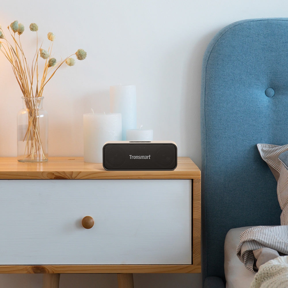 Tronsmart T2 Mini 2023 Portable Wireless Bluetooth Speaker is Placed On Side Table.