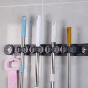 Mops and Brooms are Organized in a Wall Mounted Mop Holder.