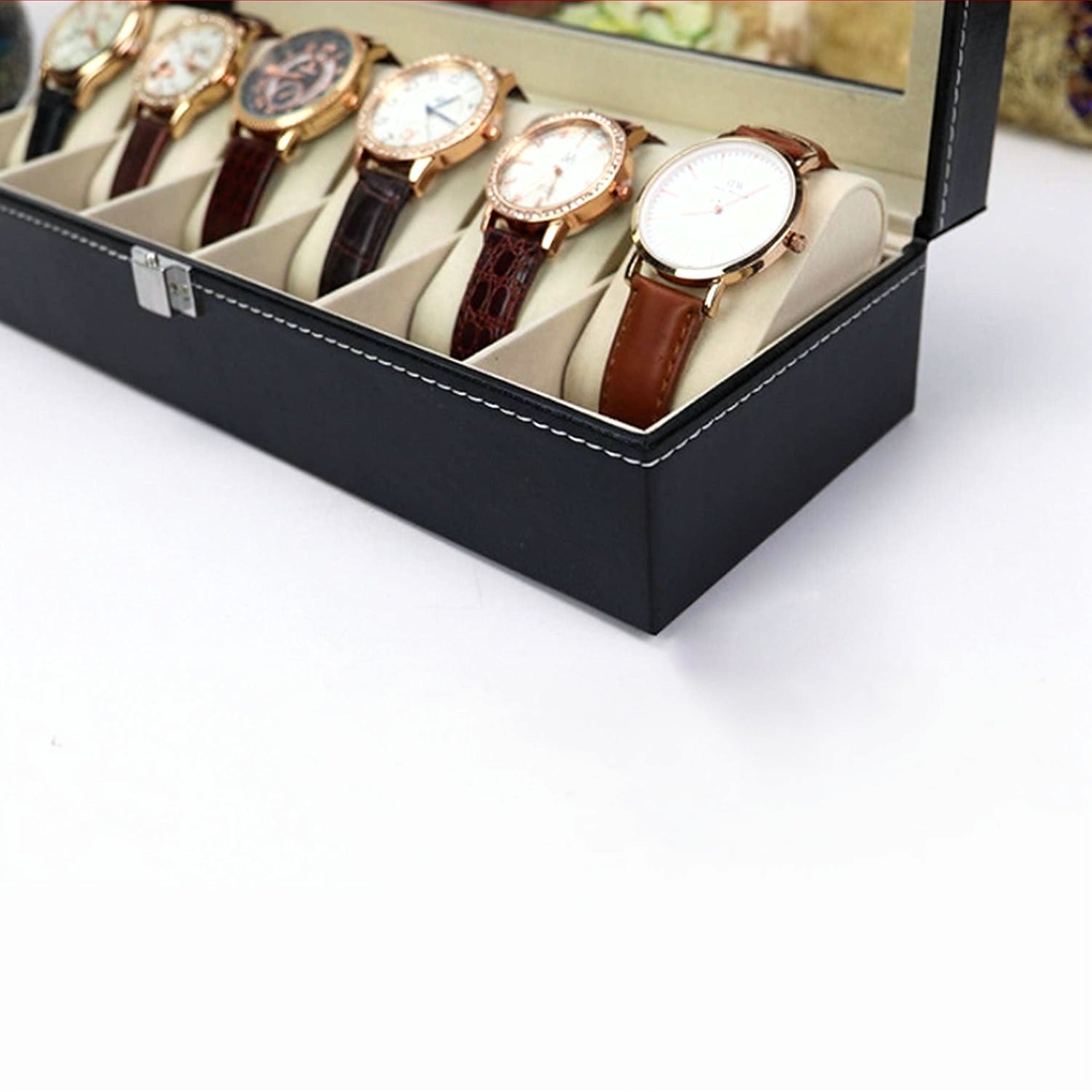 Set of watches in a black display case on a white background