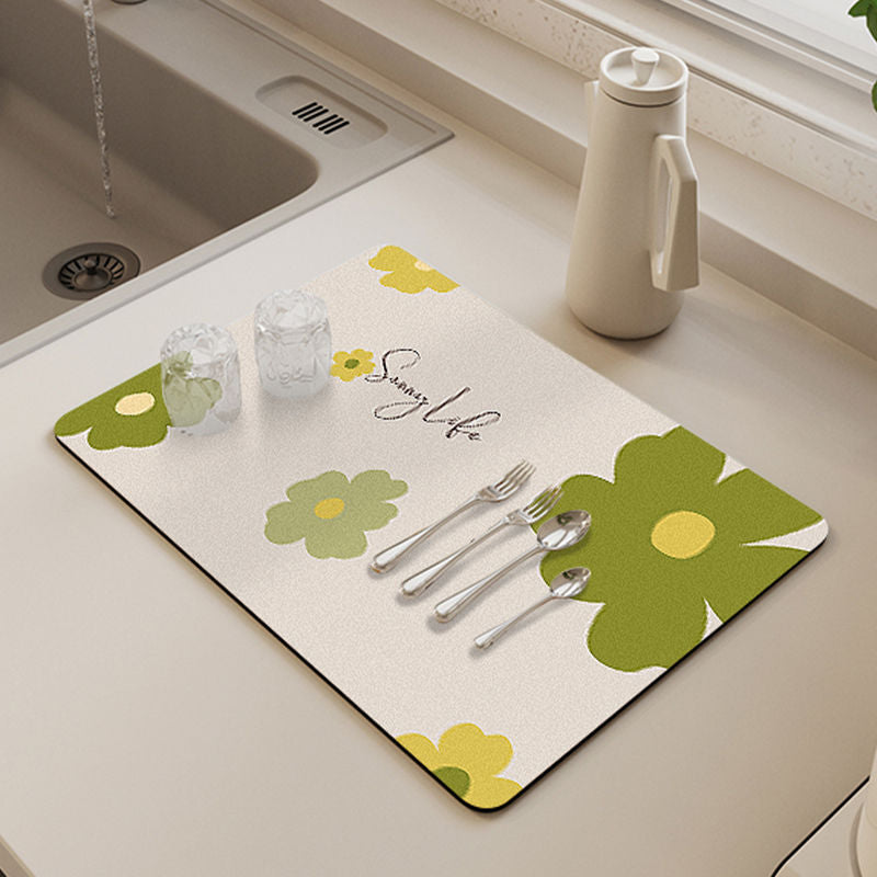 Showcasing Dish Drying Mat with spoons,forks and two glass cups kept on a kitchen counter top near to a sink