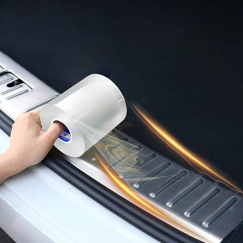 A person sticking transparent Anti-Scratch 5D Carbon Fiber Stickers on the footstep of a car 