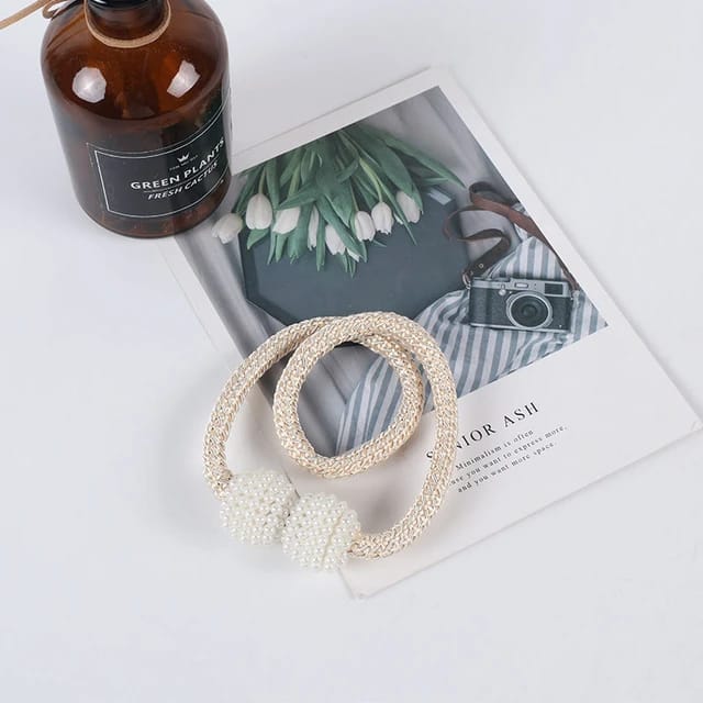 Showcasing Beige Color Magnetic Curtain Binding Rope placed on top of table