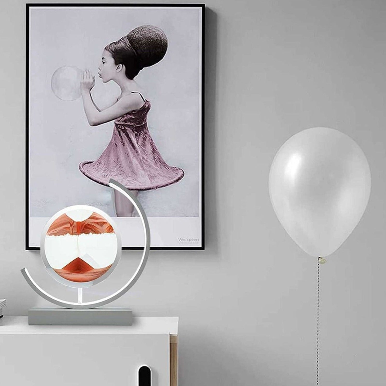 Quicksand 3D Table Lamp placed on a table near to a portrait and a balloon 