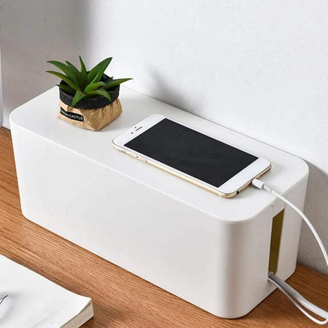 A Phone is Charging By Placing  Charger on Extension Socket Storage Box.