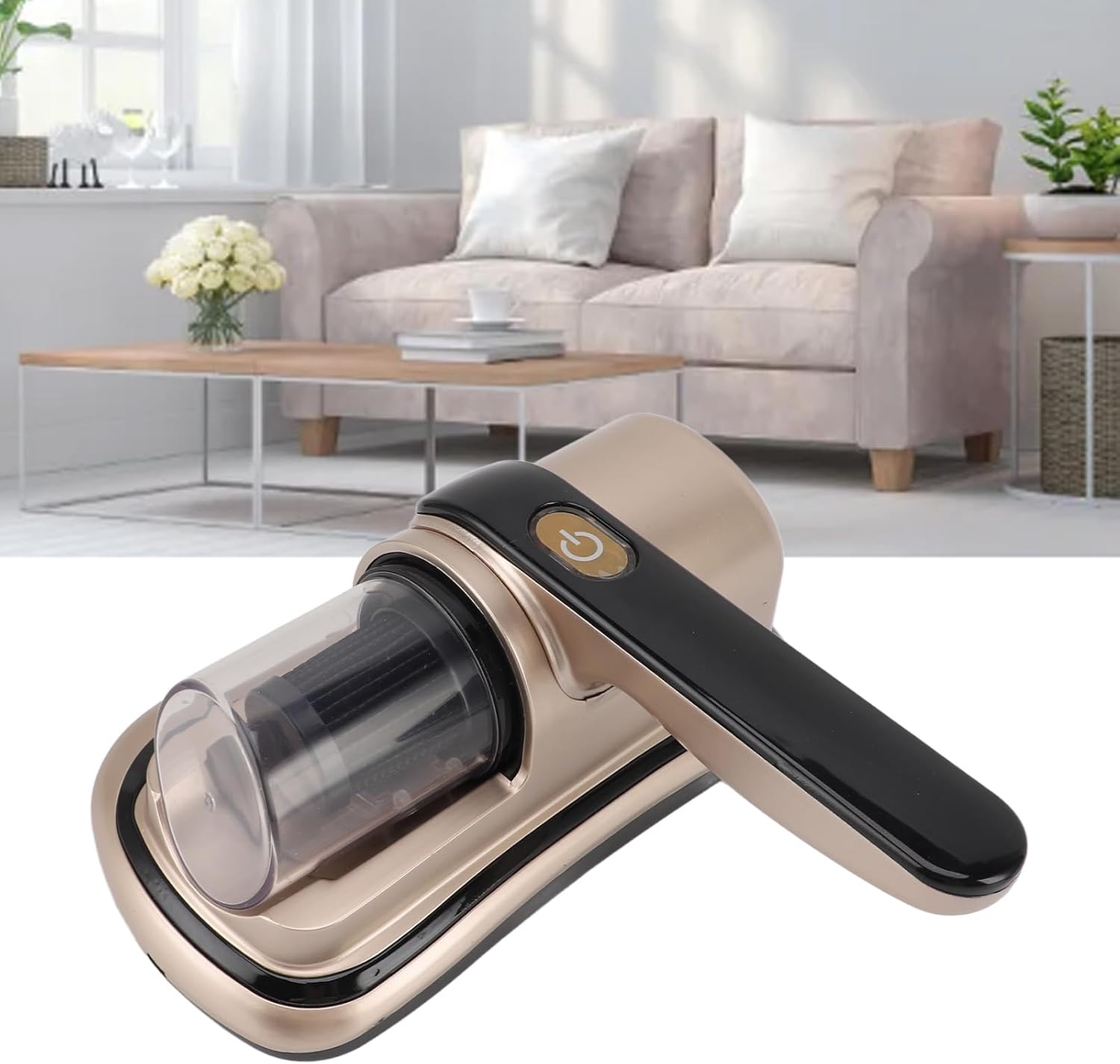 Wireless Dust Mite Removal Vacuum Cleaner with a metallic champagne-gold body, black handle, and clear dust container, shown in front of a blurred living room background with a sofa and coffee table.