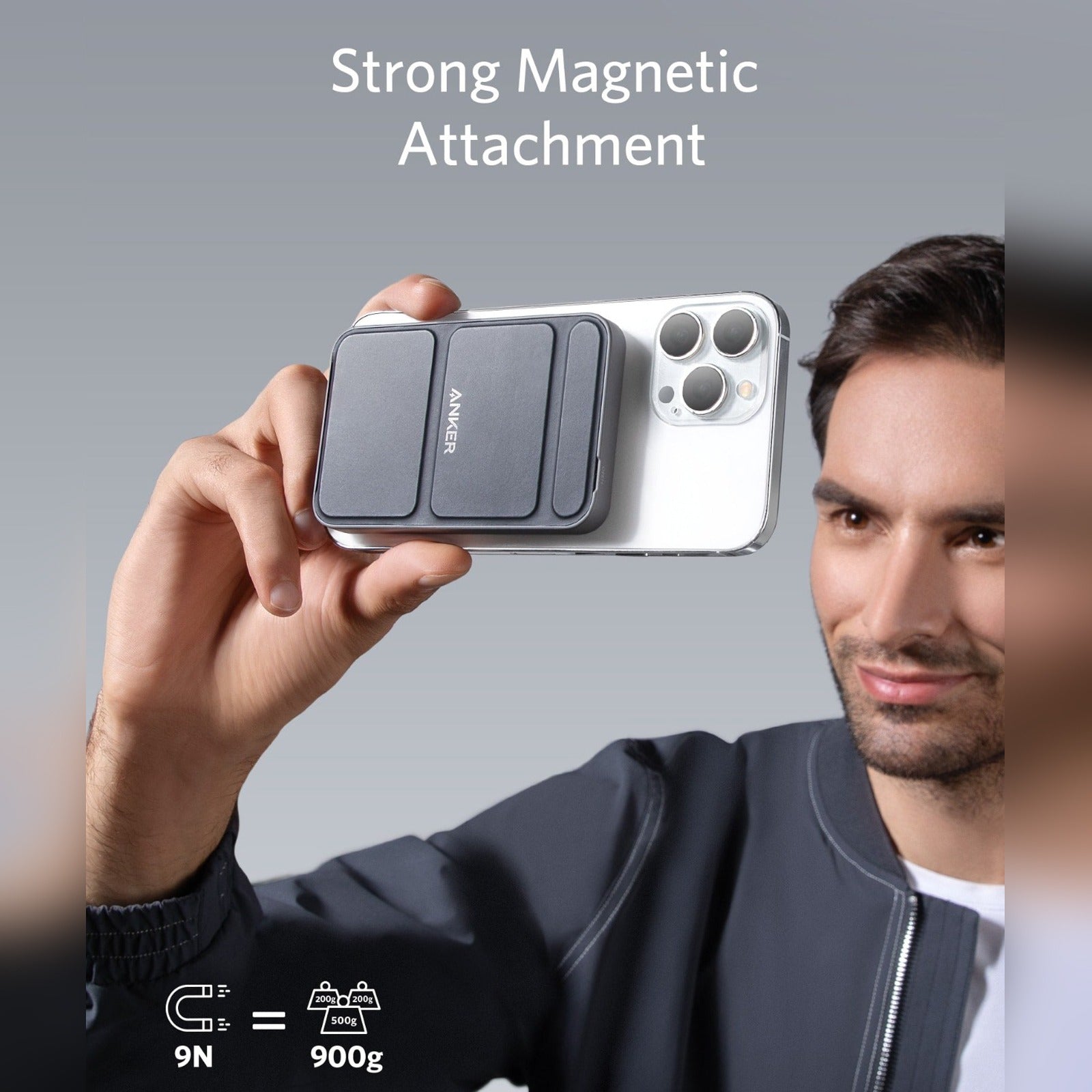 A man is holding a mobile phone connected to a 5000 mAh Wireless Portable Charger