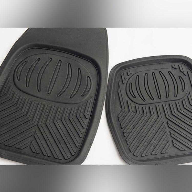 Two black car floor mats with textured surface on a white background