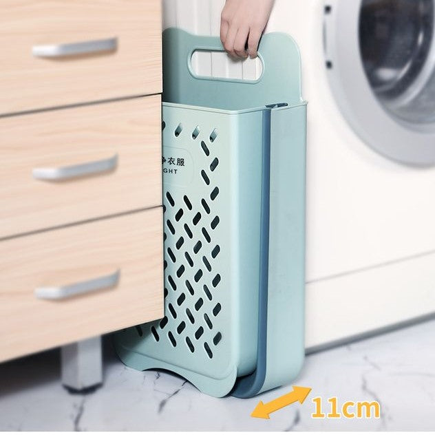 Someone holding a Collapsible Wall Mount Laundry Basket with some items in it