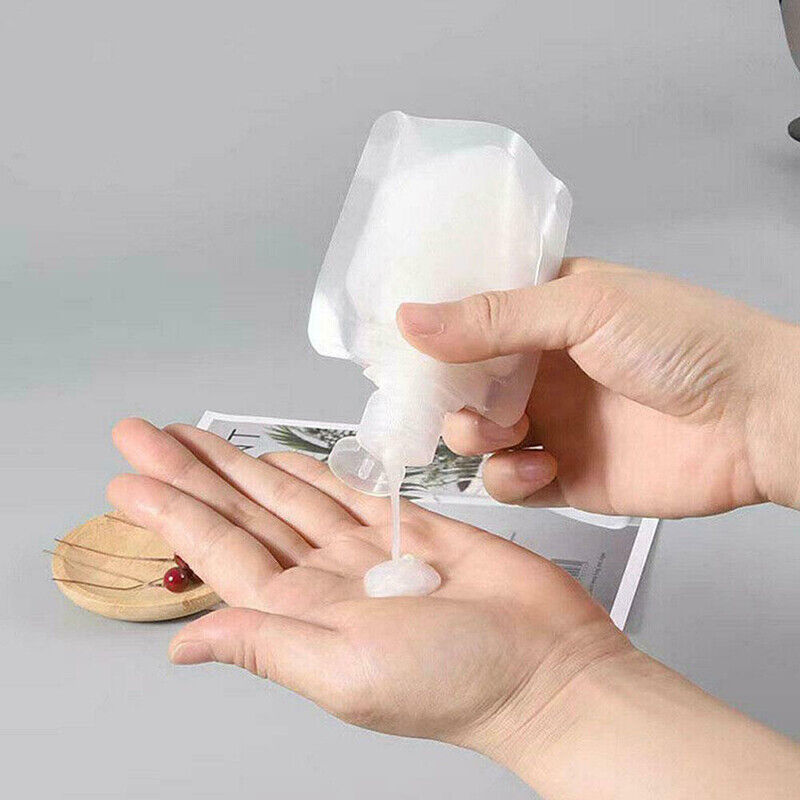 a person pouring liquid onto their hand from liquid dispenser bag
