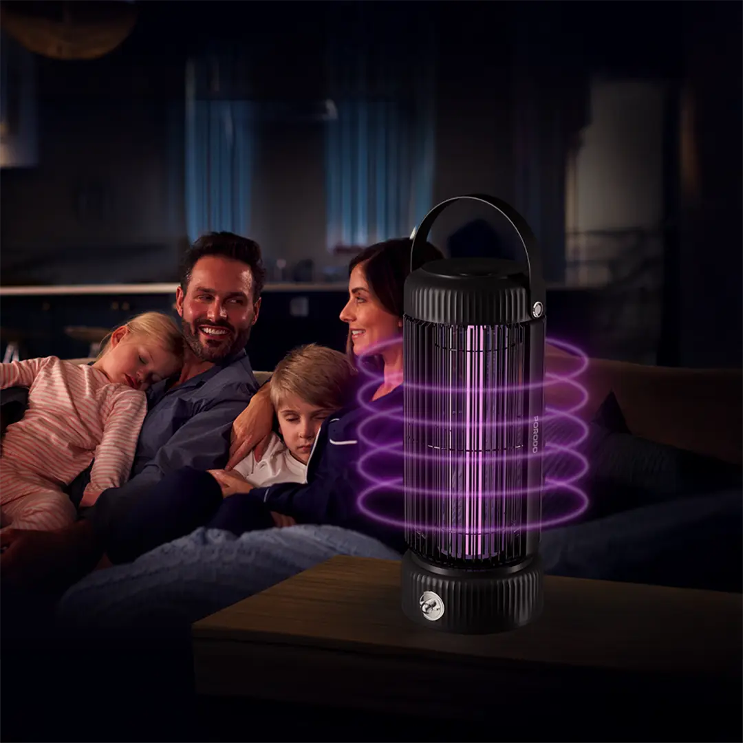 Family sitting on a couch with a Porodo Portable Mosquito Zapper emitting purple light on a dark background